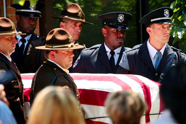 Dallas Police Officers bear casket of slain officer
