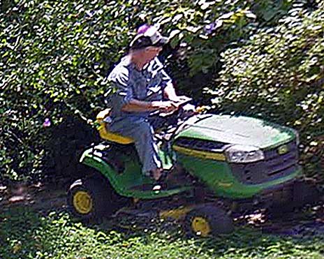 Johnny Pruett mowing his yard