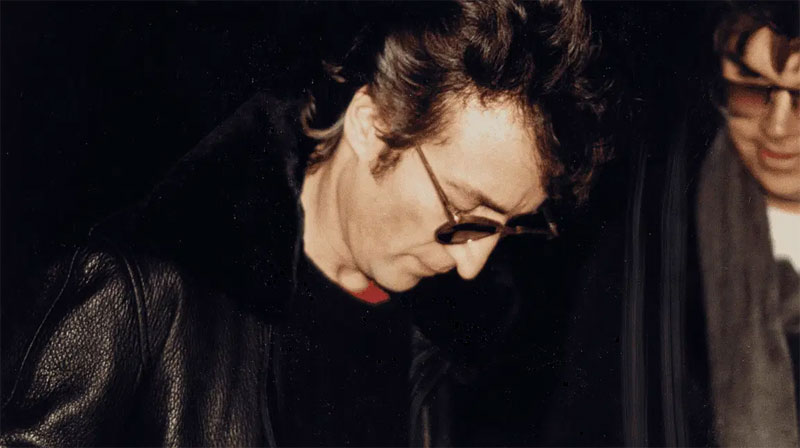 John Lennon signing autograph for Mark David Chapman